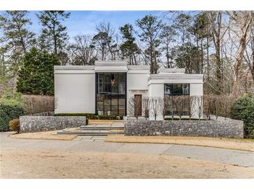 Stunning contemporary home featuring unique architecture and professional landscaping for sophisticated curb appeal at 3184 Wood Valley Nw Rd, Atlanta, GA 30327