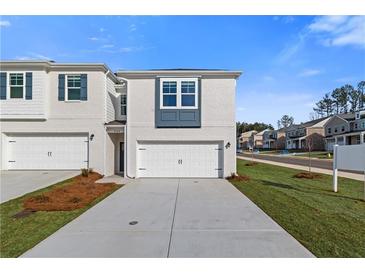 Townhouse exterior features painted brick, an attached two-car garage, and a well-manicured front yard at 200 Sanctuary Dr, Mcdonough, GA 30253