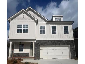 Beautiful two-story home with a stone accent and white siding, showcasing curb appeal at 273 Lakeside Pl, Canton, GA 30114