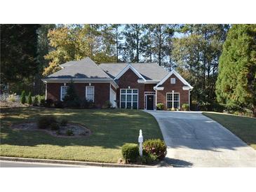 Brick ranch house with landscaped yard and long driveway at 1025 Copper Creek Dr, Canton, GA 30114