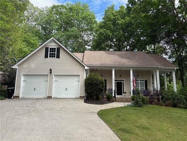 Charming single-Gathering home with a well-manicured lawn, covered porch and two-car garage at 6054 Nebo Rd, Hiram, GA 30141