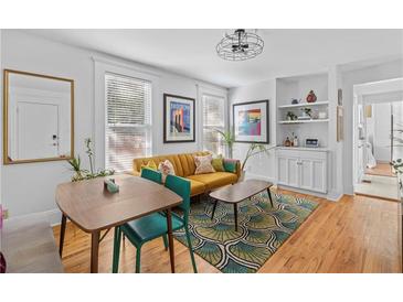 Bright living room with hardwood floors, mustard sofa, and mid-century modern furniture at 764 Edgewood Ne Ave # 1, Atlanta, GA 30307