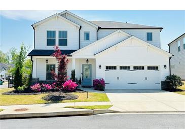 Charming two-story home with a well-maintained lawn, beautiful landscaping, and a two-car garage at 802 Oak Promenade Ln, Canton, GA 30115