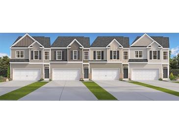 New construction townhomes featuring attached garages and a variety of neutral color schemes at 487 Reflection Dr # 34, Stockbridge, GA 30281