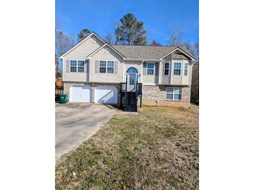 Charming two-story home featuring a two-car garage and a welcoming front entrance with stairs at 110 Lava Ct, Carrollton, GA 30116