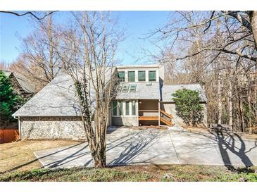 Two-story house with stone accents and a large deck at 1801 Laurel Creek Se Trl, Smyrna, GA 30080