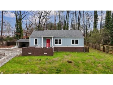 Charming blue home with red door, brick accents, and a well-maintained lawn at 589 Northern Ave, Clarkston, GA 30021