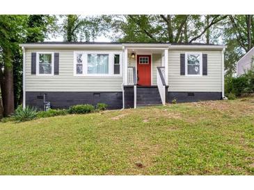 Charming home with a well-maintained lawn, a bright red front door, and stylish black shutters at 2161 Penelope Nw St, Atlanta, GA 30314