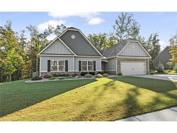 Ranch style home with gray siding, landscaping, and a two-car garage at 24 Thunderhawk Ne Ln, Rydal, GA 30171