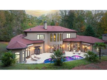 Expansive backyard features a kidney-shaped pool, lounge chairs, and meticulously maintained landscaping at 1416 Walcutts Nw Way, Marietta, GA 30064