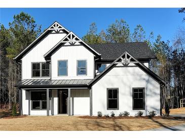 Modern farmhouse exterior with white siding, black trim, and manicured front lawn at 3785 Pilgrim Mill Rd, Cumming, GA 30041