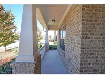 Inviting front porch with brick columns and white railing at 1079 Bar Harbor Pl, Lawrenceville, GA 30044