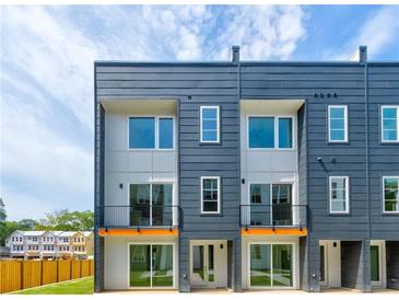 Modern townhome exterior with large windows, gray siding, and black accents at 1641 Mcnaught Dr # 35, Atlanta, GA 30317