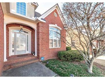 Brick home with a welcoming front porch and landscaping at 1979 Spivey Village Dr, Jonesboro, GA 30236