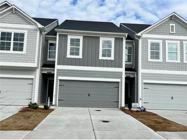 Newly constructed townhomes with a neutral color palette, two-car garages, and modern architectural details at 5178 Longview Run, Decatur, GA 30035