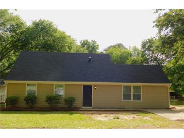Charming single-story home featuring a dark roof, neutral siding, and manicured front yard landscaping at 99 Libby Ln, Jonesboro, GA 30238