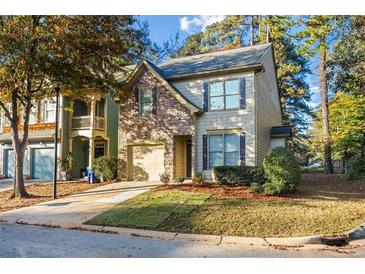 Charming two-story home with stone accents, attached garage, and manicured front lawn at 3298 Sheffield Cir, Decatur, GA 30032