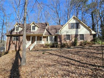 Charming two-story house with a brick facade, dormer windows, and a welcoming front porch at 25 Ridgeview Dr, Jonesboro, GA 30236