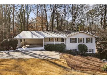 White brick ranch house with attached carport and landscaping at 655 Amberidge Trl, Atlanta, GA 30328