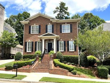 Brick two-story house with black shutters, landscaping, and a brick walkway at 962 Manor Parc Dr, Decatur, GA 30033