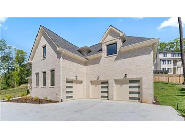 Elegant exterior elevation with a three-car garage and a light brick facade at 3785 Lower Roswell Rd, Marietta, GA 30068