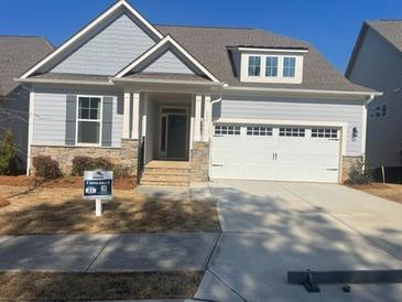 Charming single-Gathering home with a two-car garage and beautifully manicured landscaping at 159 Sunshower Rdg, Canton, GA 30114