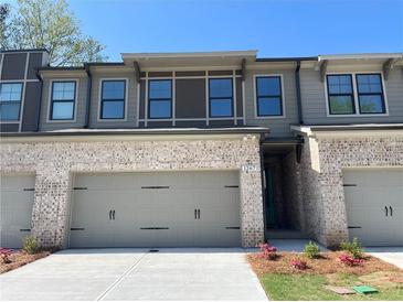 Charming townhome with brick accents, two-car garage, and a welcoming entrance at 1267 Lucan Nw Ln # Wc217, Lawrenceville, GA 30043
