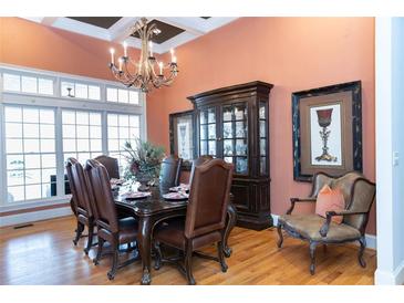 Elegant dining room with a dark wood table and leather chairs, illuminated by a decorative chandelier at 86 Waterford Path, Hiram, GA 30141