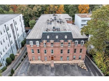 Stately brick building featuring classic architectural details and a spacious parking area, surrounded by mature trees at 3649 Peachtree Ne Rd # 201, Atlanta, GA 30319