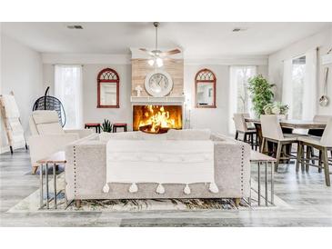 Inviting living room features a fireplace, ceiling fan, and stylish decor at 5483 Wylstream, Norcross, GA 30093