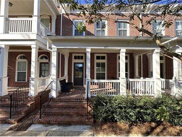 Brick townhouse with front porch and white columns at 617 Brennan Dr, Decatur, GA 30033