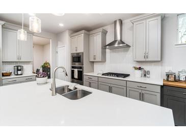 Modern kitchen with stainless steel appliances and white quartz countertops at 51 Riverbirch Way, Dallas, GA 30157
