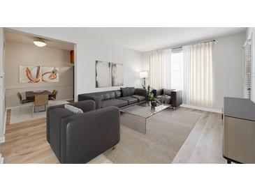 Bright living room with modern furnishings, hardwood floors, and an adjacent dining area at 1284 Piedmont Ne Ave # 5, Atlanta, GA 30309