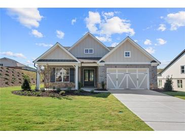 Brick front exterior of charming craftsman home with a large covered porch at 2735 Marie Way, Cumming, GA 30028