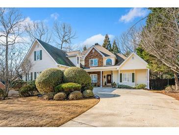 Beautiful two-story house with stone accents and manicured landscaping at 7420 Colony Ct, Cumming, GA 30041