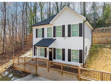 Two-story house with white siding, black shutters, and a wooden deck at 3385 Continental Dr, Cumming, GA 30041