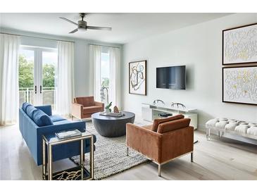 Bright living room with modern furnishings, stylish decor, and balcony access at 775 Juniper Ne St # 614, Atlanta, GA 30308