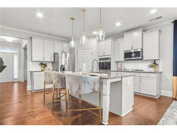 Modern kitchen with stainless steel appliances and an island at 3210 Ancoats St, Douglasville, GA 30135