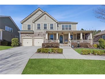 Charming two-story home with stone accents, neutral siding, covered front porch and well manicured lawn at 3213 Blackley Old, Douglasville, GA 30135