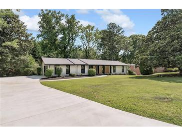 Ranch style home with a large front yard and long driveway at 2649 Sunrise Ne Dr, Atlanta, GA 30345