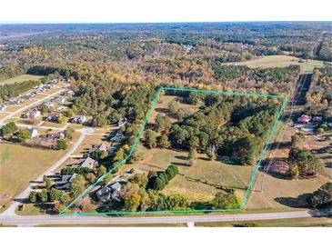 Large lot surrounded by mature trees and potential for new development in established neighborhood at 4409 Shiloh Rd, Loganville, GA 30052