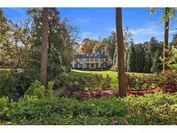 Majestic two-story home featuring a manicured front lawn and lush landscaping at 420 Argonne Nw Dr, Atlanta, GA 30305