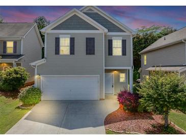 Charming two-story home features a two-car garage, neutral siding and dark shutters at 363 Lobdale Falls Dr, Lawrenceville, GA 30045