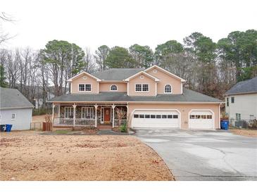 Two-story house with stone accents, porch, and attached garage at 2068 Lakewood Cir, Grayson, GA 30017