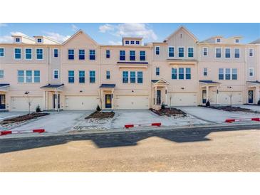 New townhomes boast painted brick facade, individual garages, and inviting front entryways at 3269 Durston Ct, Dacula, GA 30019