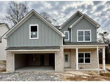 New construction home with a stone facade, attached garage, and inviting covered porch at 2955 Jefferson St, Austell, GA 30106