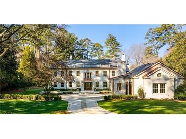 Stately two-story home with mature trees and a circular driveway, offering timeless elegance and curb appeal at 3488 Tuxedo Nw Rd, Atlanta, GA 30305