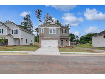 Charming two-story home with a brick and siding facade and a two-car garage at 16 Camellia Dr, Fairburn, GA 30213