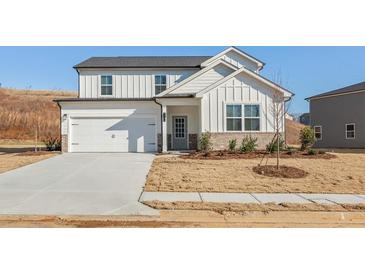 Charming two-story home featuring a two-car garage and a welcoming front porch at 4171 Viola Pl, Atlanta, GA 30349