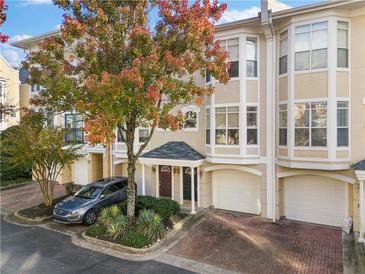 Attractive 3-story townhome with autumn trees and a Volvo in the driveway at 375 Highland Ne Ave # 908, Atlanta, GA 30312